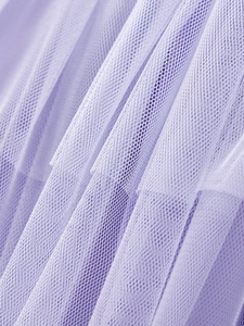 Close-up of soft purple multilayer mesh fabric with delicate tulle texture on girls dress