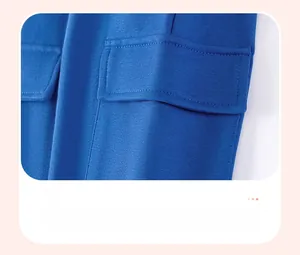 Detail of the blue cargo pants showing the functional patch pocket with neat stitching