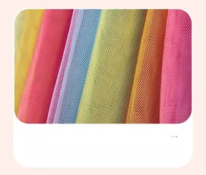 Detail of colorful multi-layered tulle fabric with vibrant mesh texture and contrast ruffles