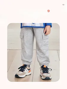Detail of grey cotton cargo pants for boys featuring practical side pockets and ribbed cuffs