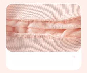 Close-up of pink cotton fabric showing high-quality inner stitching and double-hemmed seams