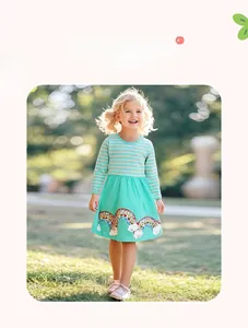 Close-up of girls long-sleeve dress with yellow stripes and rainbow cloud patterns
