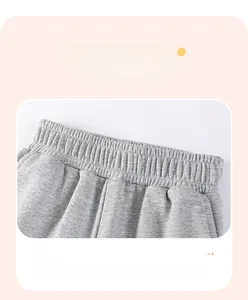 Detailed close-up of comfortable elastic waistband on gray knitted boys cargo pants