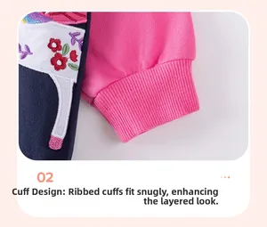 Detail of pink cotton sweatshirt sleeve with floral embroidery and ribbed cuffs