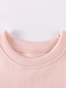 Pink crewneck sweatshirt for girls showing ribbed neckline and fine stitching details