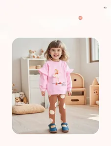 Girl's pink ballet-print sweatshirt and brown polka dot pants set in a home setting