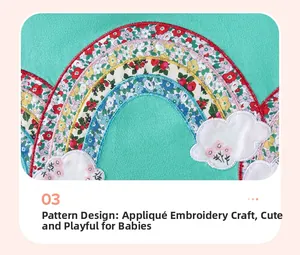 Detail of mint green girls' dress featuring floral rainbow applique and embroidery