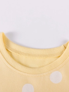 Light yellow polka dot cotton dress for girls featuring a classic round neckline