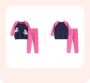 Flat lay of cotton kids unicorn loungewear set featuring pink sleeves and pants