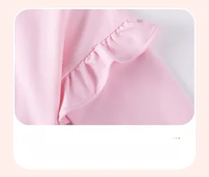 Close-up of pink cotton knit top featuring decorative shoulder ruffles and soft texture