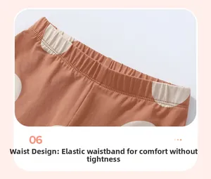 Detailed view of kids caramel cotton pants with white polka dots and elastic waistband