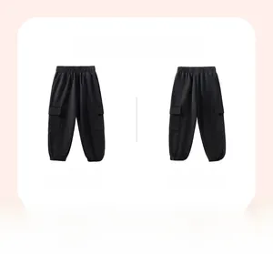 Detail of kids black cargo pants with elastic waistband and large side flap pockets