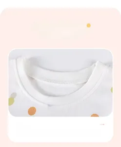 Detail of baby girl cotton dress with colorful polka dots and ribbed crew neck stitching