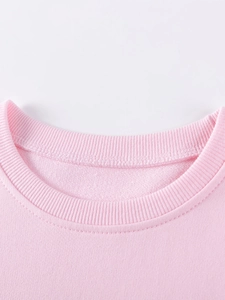Close-up of pink cotton sweatshirt neckline with durable ribbed collar and stitching