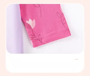 Detail of pink cotton baby dress sleeve with tulip discharge print and knit texture