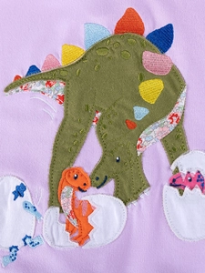 Girls purple cotton dress featuring cute green dinosaur applique with floral fabric detail