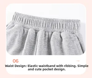Détail d'un sweat à capuche gris pour enfant avec taille élastique et poche latérale