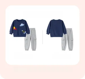 Detail of space-themed rocket and UFO embroidery on a navy boys' sweatshirt set