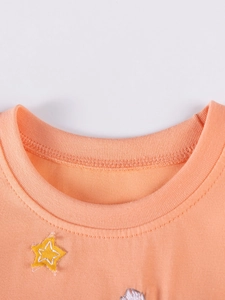 Abito arancione in cotone per bambine con scollo rotondo e decorazione a stella gialla
