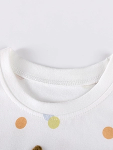 Toddler girl's white cotton dress with colorful polka dots and ribbed crew neck detail