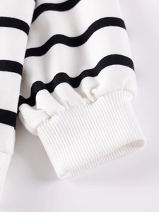 Striped girls clothing set with long sleeves and white ribbed cuffs close-up shot