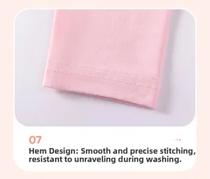 Detail view of pink cotton trousers showing fine double-needle stitching on the leg cuffs