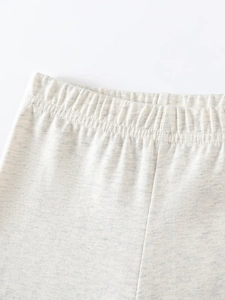 Pantaloni in maglia per bambine color avena con vita elastica e morbida trama a coste
