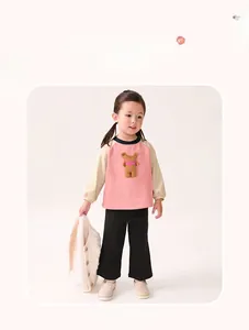 Detail of girls' long sleeve cotton set featuring cute 3D bear patch and pink contrast design