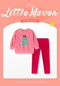 Detail of Christmas girl set with pink sweatshirt, tree print and red slim trousers