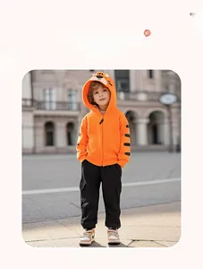 Close-up of boys orange tiger-themed hoodie and black joggers for outdoor activewear