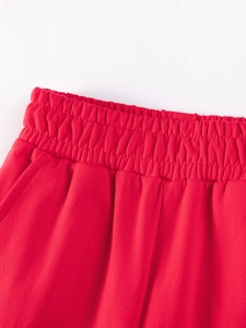 Christmas kids' red knit sports pants with elastic waistband and side pockets