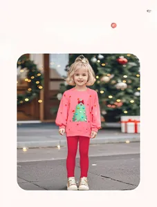 Detailed view of pink Christmas tree sweatshirt and red slim-fit knit trousers for girls