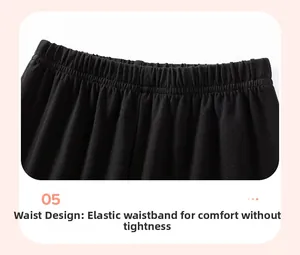 Detail view of the elastic waistband with gathered folds on black knit toddler trousers