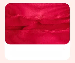 Detailed close-up of premium stitching on red fleece sweatshirt showing quality seamwork