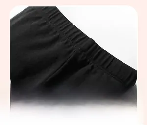 Detail view of the wide elastic waistband on these black cotton girl's leggings