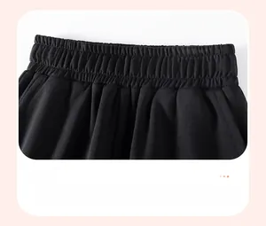 Detail of elastic waistband and side pockets on boys' black fleece-lined joggers