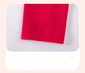 Detail of red knit cotton pants hem with high-quality double-needle stitching finish