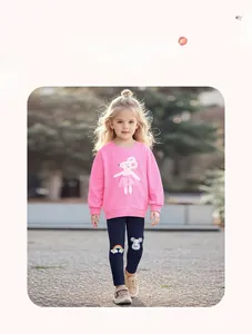 Detail of girls' pink long sleeve sweatshirt with 3D tutu mouse and rainbow leggings