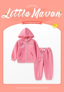 Detail of pink cotton tracksuit showing unicorn embroidery and rainbow sleeve stripes