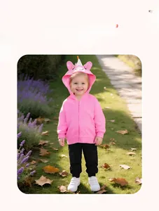 Pink toddler unicorn zip hoodie with 3D ears and horn shown in an outdoor park setting