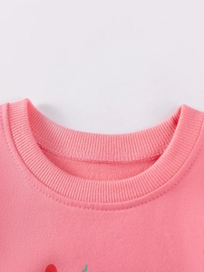 Pink round neck girls sweatshirt featuring ribbed collar and soft cotton texture