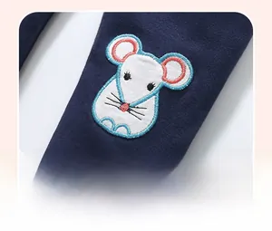 Close-up of vibrant mouse embroidery on navy blue knit fabric for girls' clothing