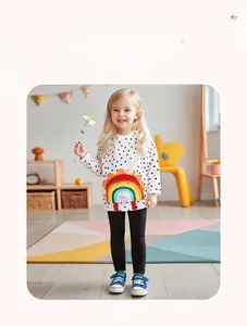 Detail of colorful rainbow crossbody bag paired with polka dot outfit for toddler girls