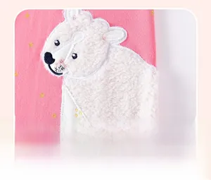 Macro detail of polar bear applique embroidery on pink star pattern cotton girl's dress