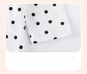 Close-up of minimalist polka dot cuffs with double-needle stitching on cotton fabric