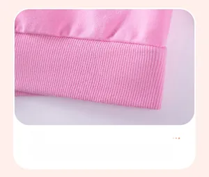 Detailed view of the pink cotton sweatshirt's elastic ribbed hem and fine knit texture