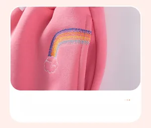 Close-up of pink knit kids trousers featuring colorful rainbow embroidery and side pocket