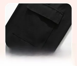 Detail shot of the black cotton sweatshirt featuring a side patch pocket with a flap