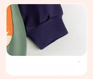Detail of navy blue ribbed cuffs and orange fox print on green cotton boy's sweatshirt