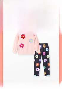 Detail of pink sweatshirt with 3D floral accents and floral print pants for girls